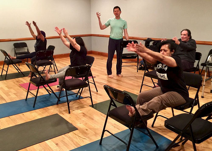 Photo of a group of people participating together in a physical class.